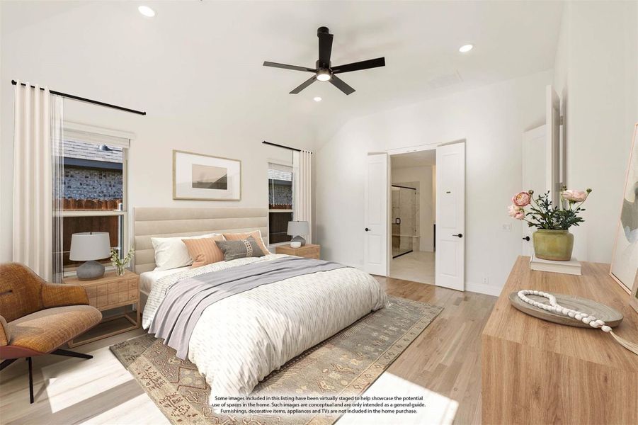 Bedroom with vaulted ceiling, ceiling fan, hardwood floors, and open ensuite bathroom door