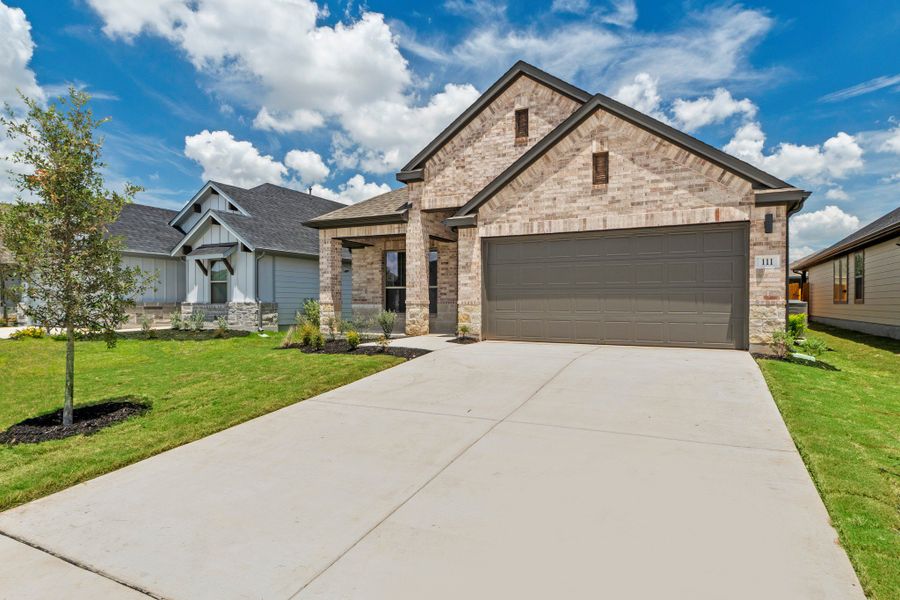 Front exterior of a new home in Prairie Winds, Hutto, TX, highlighting curb appeal (Image 2). Front exterior of a new home in Prairie Winds, Hutto, TX, highlighting curb appeal (Image 2).