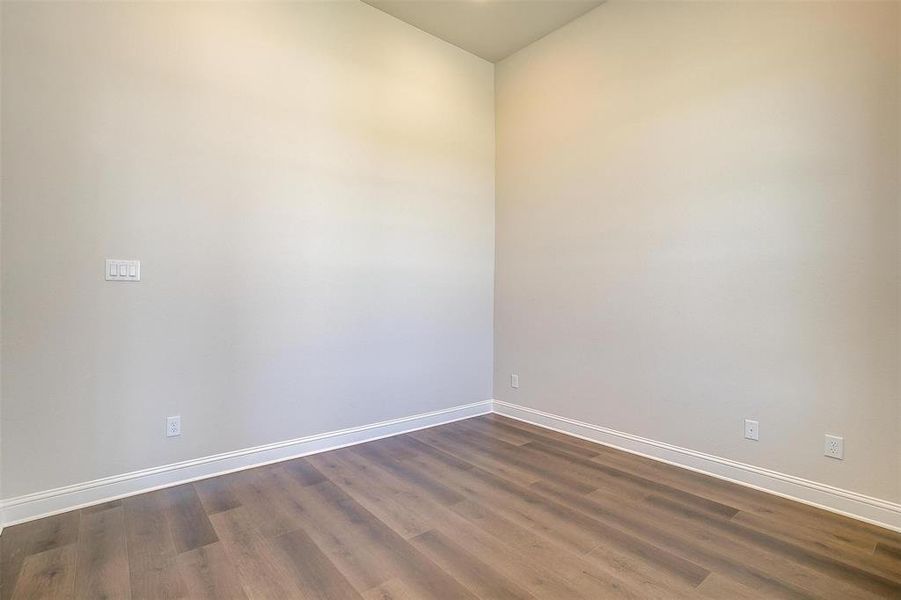 Spare room with wood-type flooring