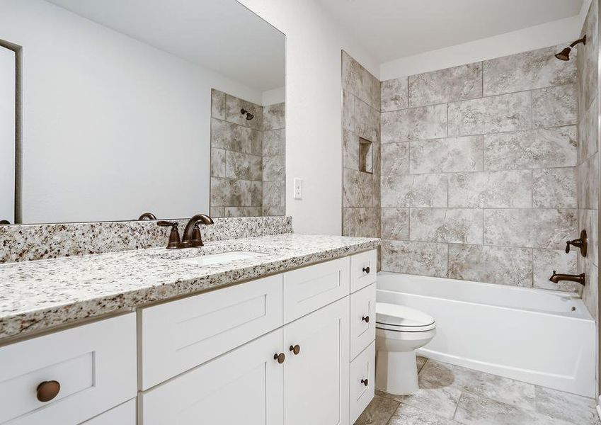 Secondary bathroom with stunning tile and a dual shower and tub.