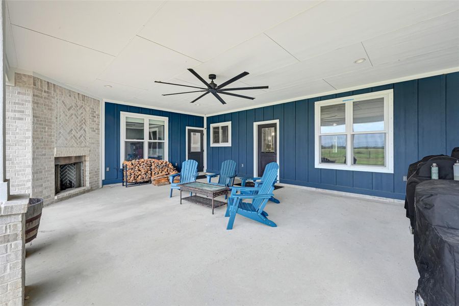 Oversized patio with ceiling fan and wood burning fireplace