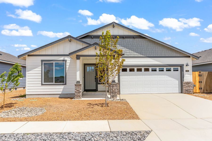 Front exterior of a new home in IronHorse, Prineville, OR, highlighting curb appeal (Image 2). Front exterior of a new home in IronHorse, Prineville, OR, highlighting curb appeal (Image 2).