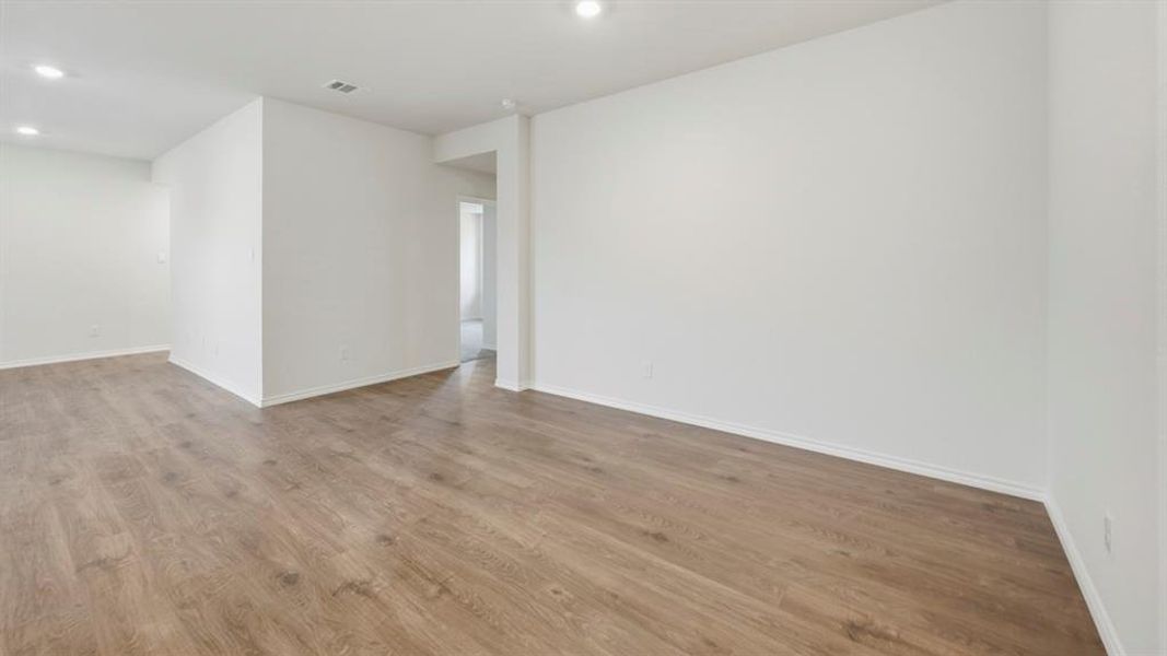 Spare room featuring wood finished floors and recessed lighting Spare room featuring wood finished floors and recessed lighting
