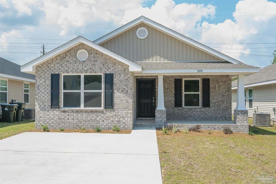 Front exterior of a new home in Westpointe Place, Pensacola, FL, highlighting curb appeal (Image 1).