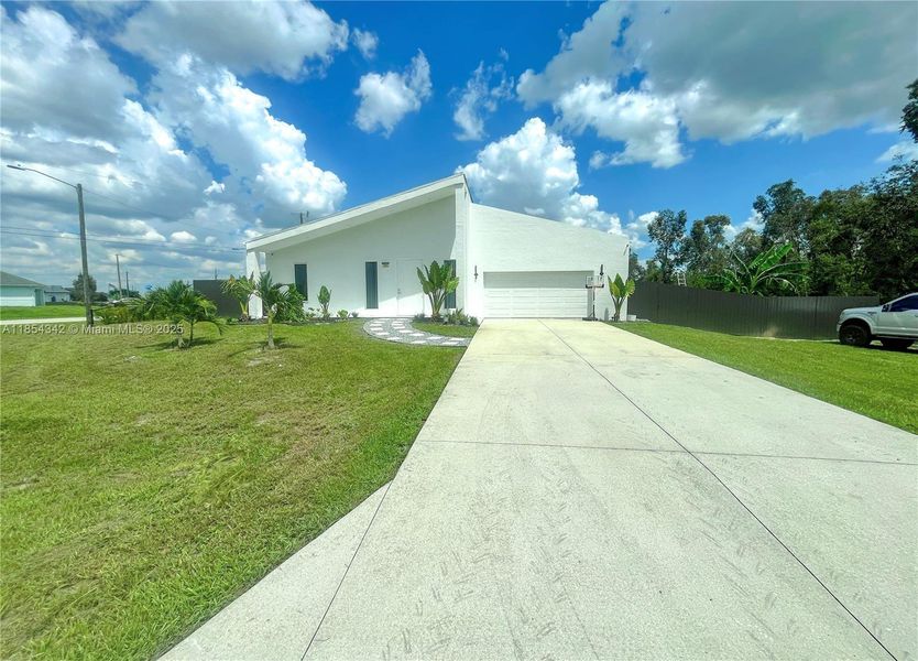 Front exterior of a new home in , Lehigh Acres, FL, highlighting curb appeal (Image 22). Front exterior of a new home in , Lehigh Acres, FL, highlighting curb appeal (Image 22).