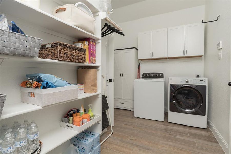Large washer and dryer with cusom cabinets