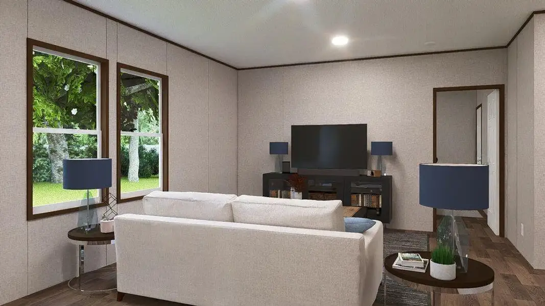 Spacious living area featuring wood-finish flooring, two large windows with dark wood trim, recessed ceiling lighting, and a doorway leading to an additional space Spacious living area featuring wood-finish flooring, two large windows with dark wood trim, recessed ceiling lighting, and a doorway leading to an additional space