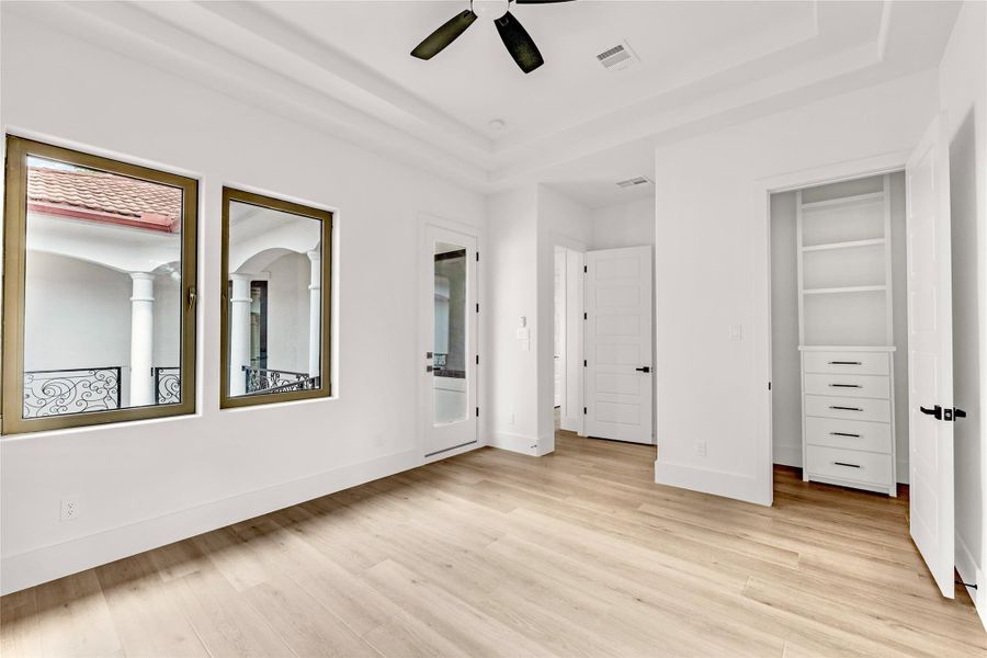 Bedroom 3 with access to the wrap-around balcony overlooking the courtyard. All bedroom closets have built-in dressers, shelves and rods Bedroom 3 with access to the wrap-around balcony overlooking the courtyard. All bedroom closets have built-in dressers, shelves and rods