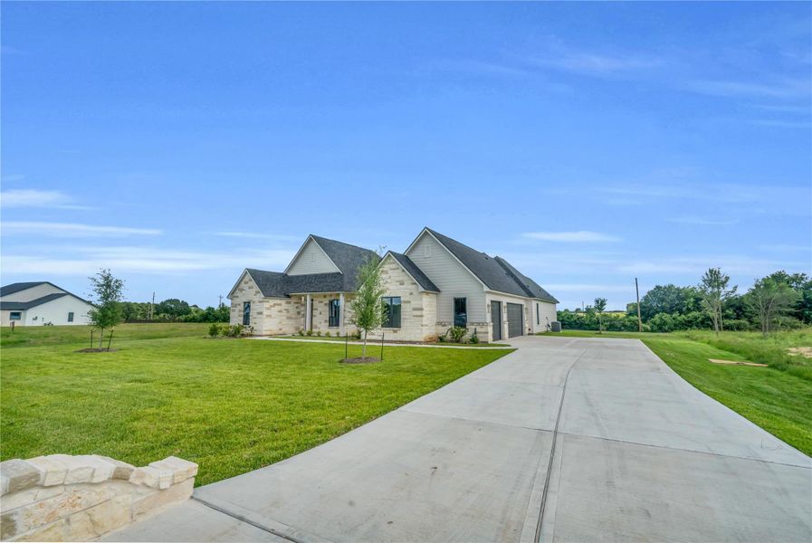 Front exterior of a new home in Chapel Bend, Montgomery, TX, highlighting curb appeal (Image 1). Front exterior of a new home in Chapel Bend, Montgomery, TX, highlighting curb appeal (Image 1).