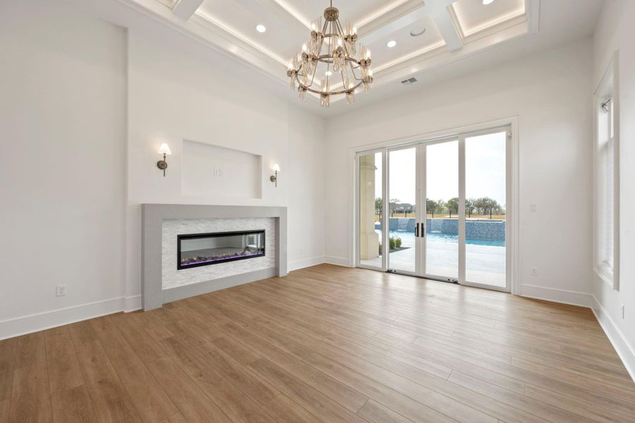 Inviting master bedroom with linear fireplace overlooks beautiful back yard