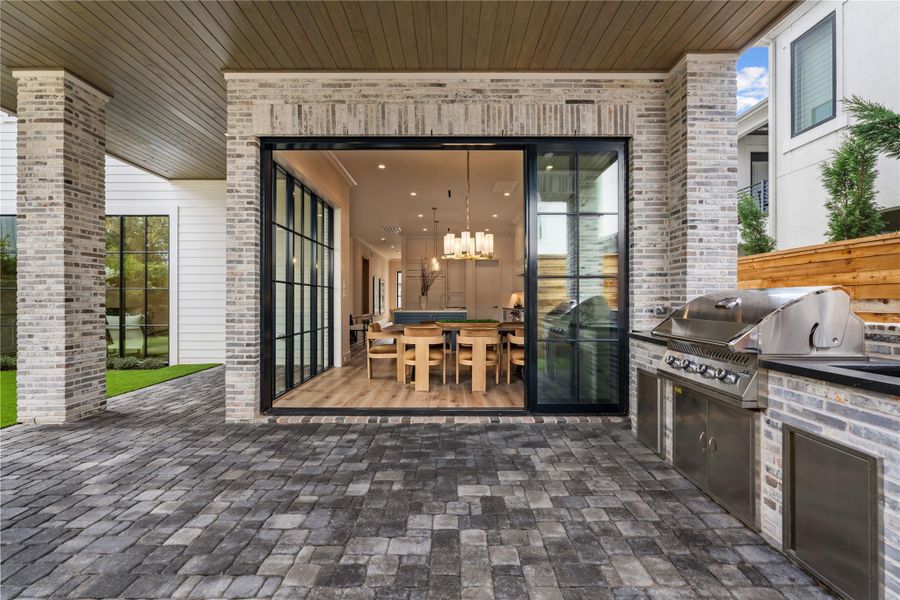 Honed quartz countertops and a showpiece Napoleon 500-series gas grill make the pavilion a showcase. The same multi-colored gray brick from the facade bricks add some spice and tie different tones together. There’s plenty of extra storage in the stainless cabinets below.