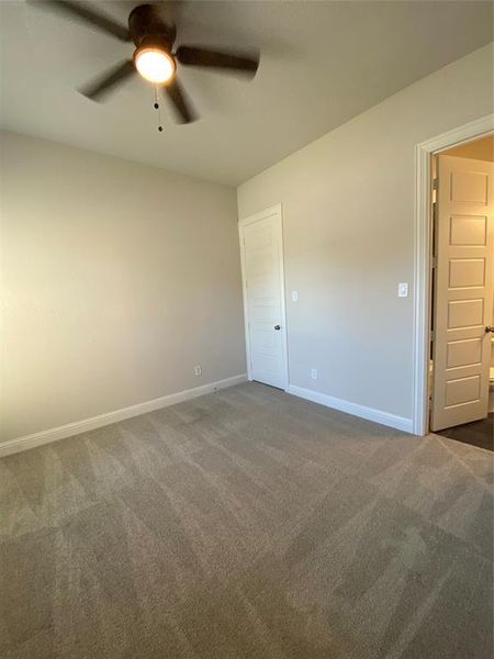 Spare room with dark carpet and ceiling fan Spare room with dark carpet and ceiling fan