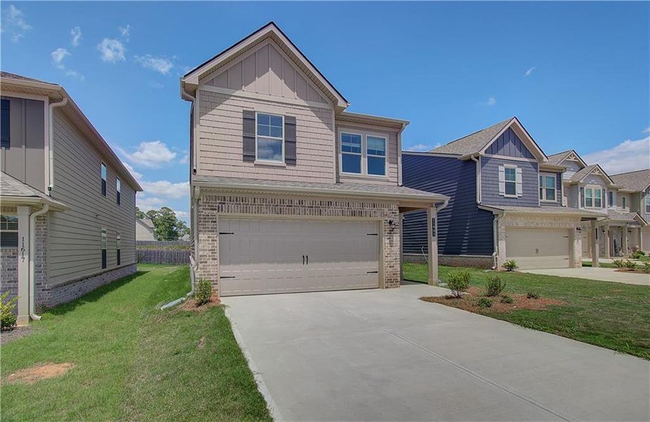 Front exterior of a new home in Towne Center, Hampton, GA, highlighting curb appeal (Image 15). Front exterior of a new home in Towne Center, Hampton, GA, highlighting curb appeal (Image 15).