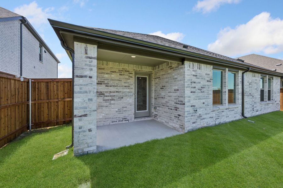 Covered patio in the Heisman home plan by Trophy Signature Homes – REPRESENTATIVE PHOTO Covered patio in the Heisman home plan by Trophy Signature Homes – REPRESENTATIVE PHOTO