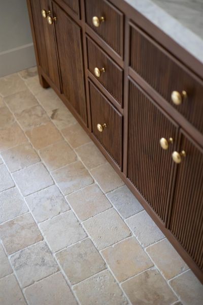 Primary bath has Warm-toned floor travertine tiling featuring a varied pattern Primary bath has Warm-toned floor travertine tiling featuring a varied pattern