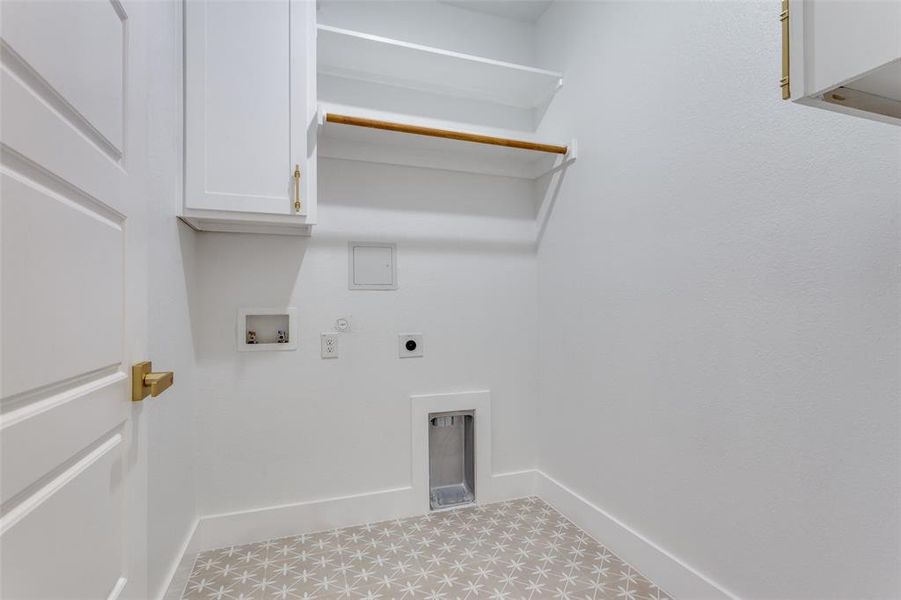 Clothes washing area with cabinets, washer hookup, hookup for an electric dryer, and hookup for a gas dryer