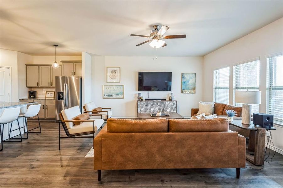 Living room featuring ceiling fan and dark hardwood / wood-style floors