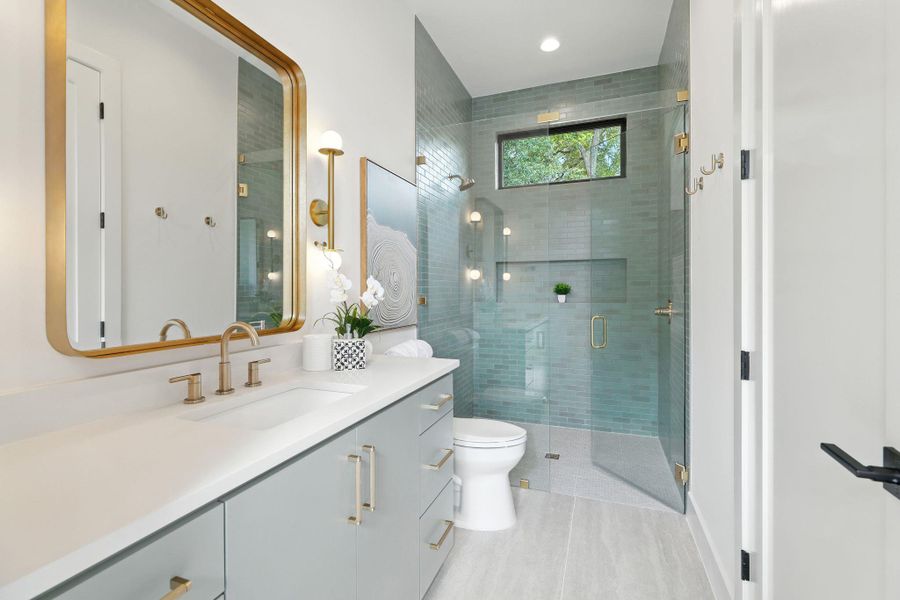 Bathroom with vanity and a shower stall Bathroom with vanity and a shower stall