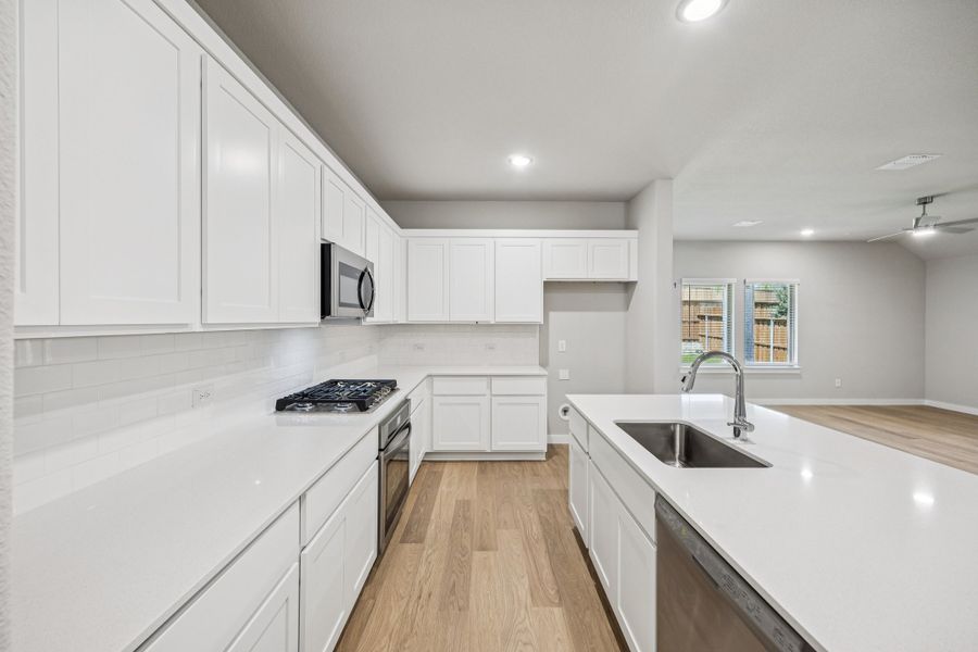 Kitchen in the Oscar home plan by Trophy Signature Homes – REPRESENTATIVE PHOTO Kitchen in the Oscar home plan by Trophy Signature Homes – REPRESENTATIVE PHOTO