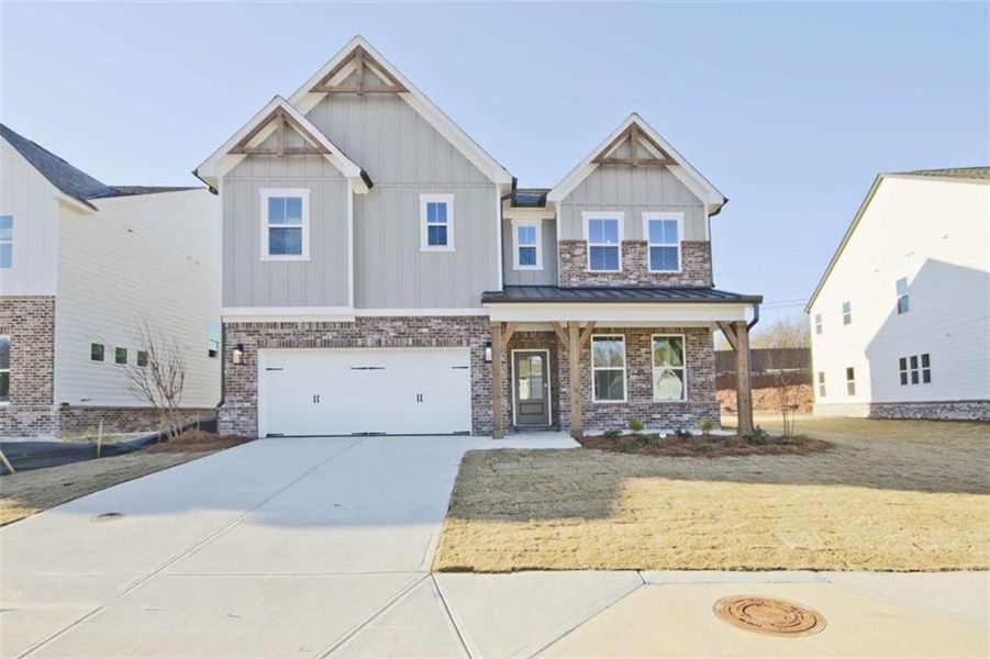 Front exterior of a new home in The Paddocks at Doc Hughes, Buford, GA, highlighting curb appeal (Image 1).