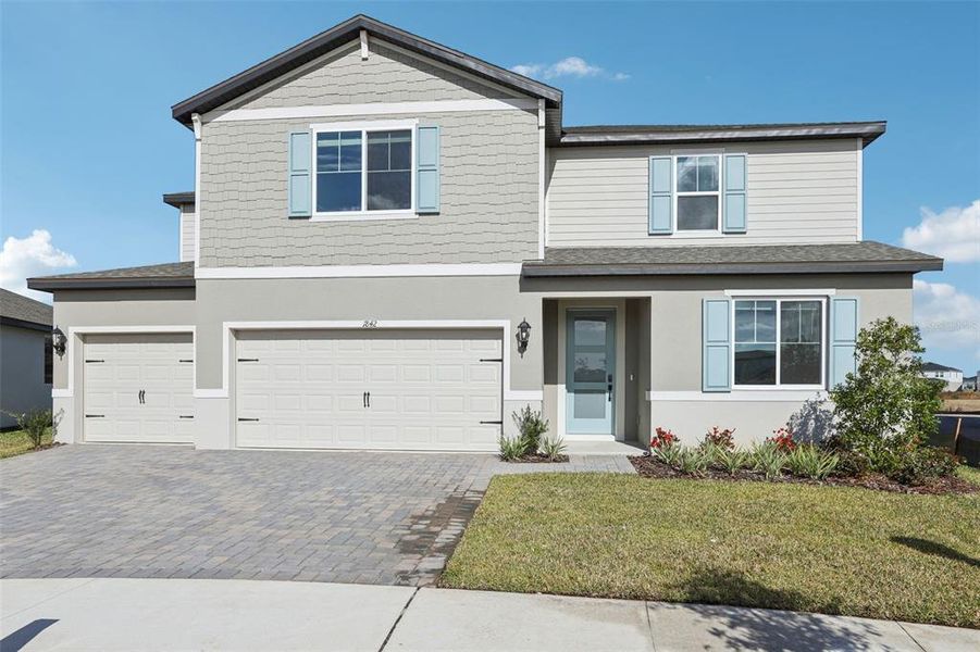 Front exterior of a new home in Two Rivers - Signature Series, Zephyrhills, FL, highlighting curb appeal (Image 26). Front exterior of a new home in Two Rivers - Signature Series, Zephyrhills, FL, highlighting curb appeal (Image 26).