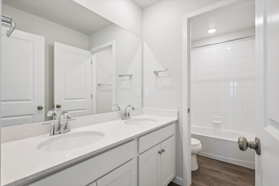 A bathroom with a sink toilet and shower. A bathroom with a sink toilet and shower.