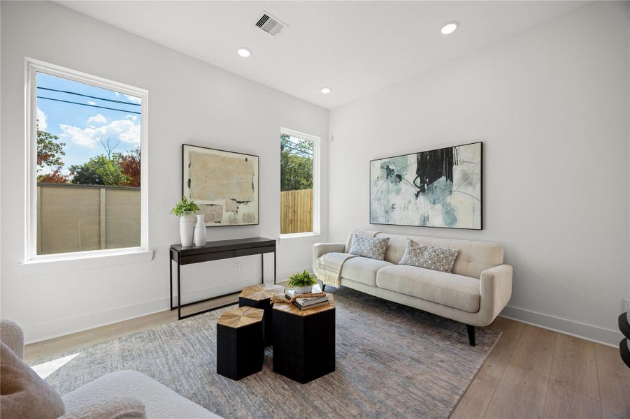 This bright and airy Living Room offers a spacious layout ideal for both relaxing evenings and lively gatherings. Designed for comfort and connection, it features vinyl plank flooring, large windows, high ceilings with recessed lighting, and seamless access to the stunning kitchen—perfect for everyday living and entertaining alike. This bright and airy Living Room offers a spacious layout ideal for both relaxing evenings and lively gatherings. Designed for comfort and connection, it features vinyl plank flooring, large windows, high ceilings with recessed lighting, and seamless access to the stunning kitchen—perfect for everyday living and entertaining alike.