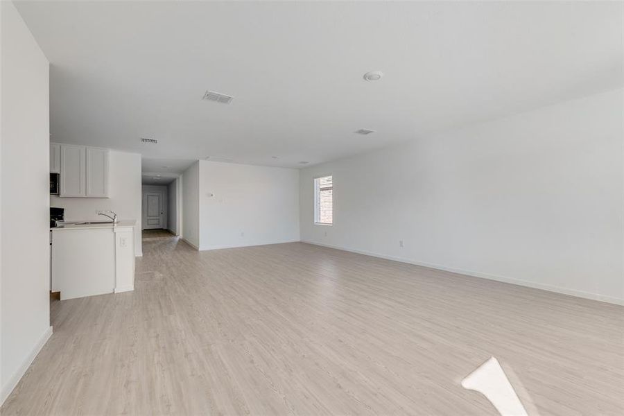 Spare room featuring sink and light hardwood / wood-style flooring