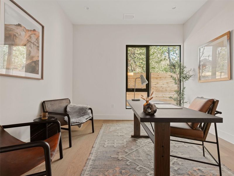 Home office featuring light wood-style floors and baseboards