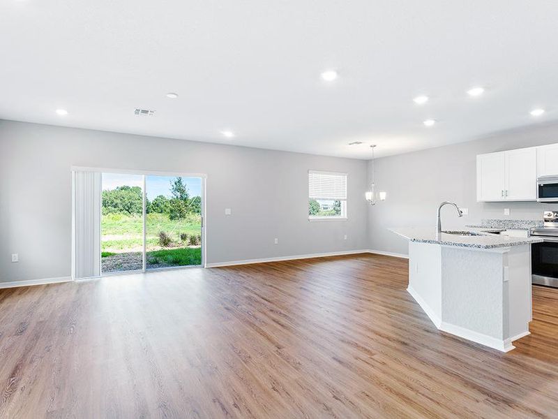 Enjoy a sunny, open living area finished with luxury vinyl plank flooring.