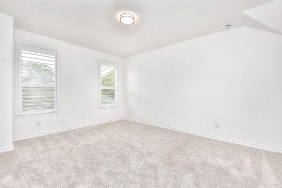 Empty room featuring carpet and baseboards
