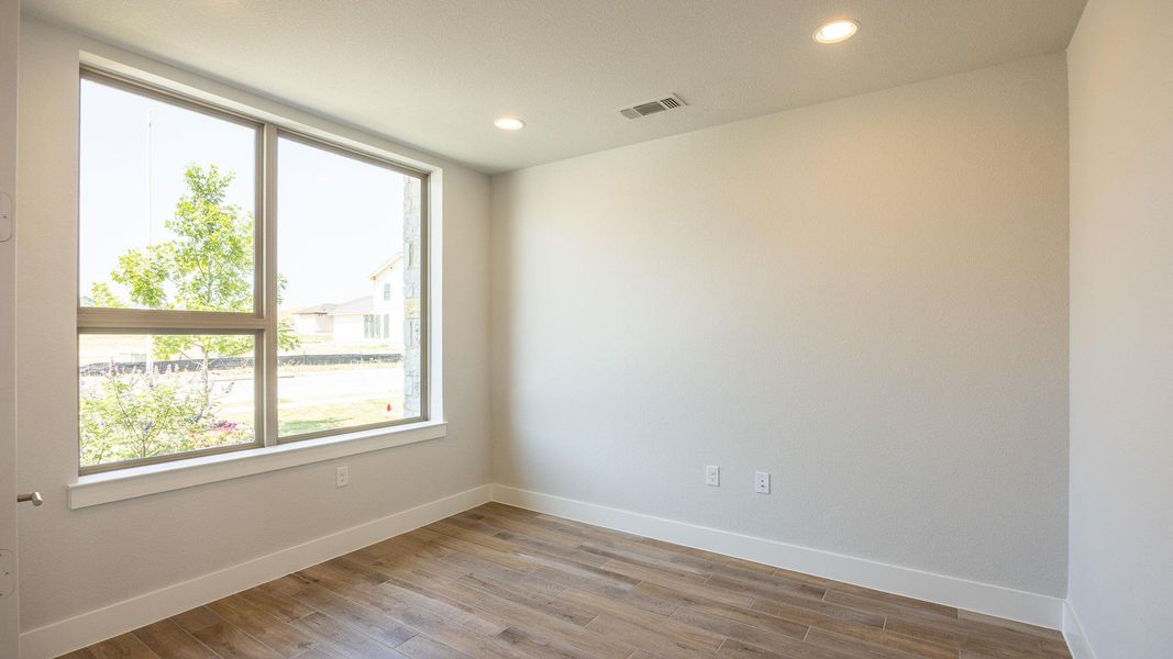 Spare room featuring baseboards, wood finished floors, and recessed lighting Spare room featuring baseboards, wood finished floors, and recessed lighting