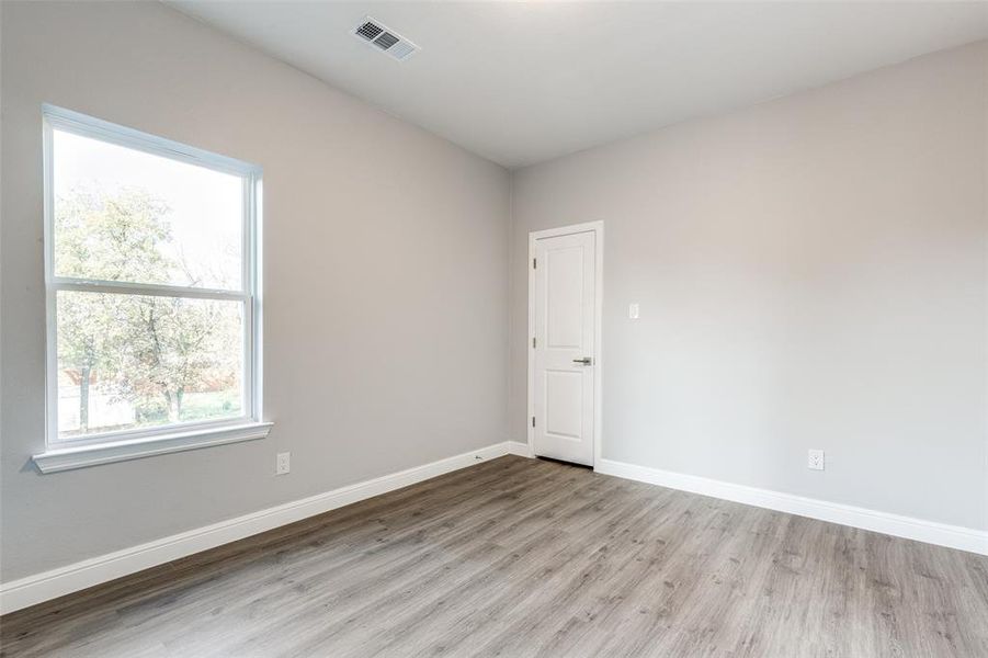 Unfurnished room with light hardwood / wood-style floors