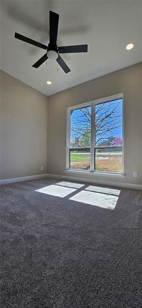 Carpeted spare room featuring a ceiling fan and recessed lighting Carpeted spare room featuring a ceiling fan and recessed lighting