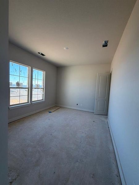 Empty room with baseboards and concrete floors