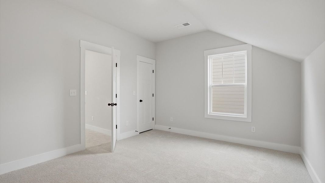 First-rate secondary bedroom with a spacious walk-in closet and elegant carpeted flooring located in Greenville, SC