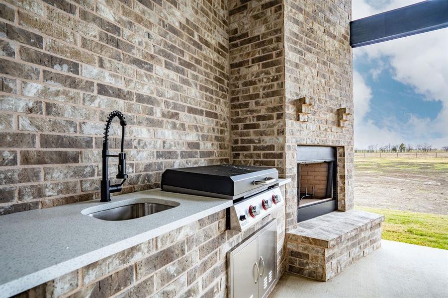 View of patio / terrace with an outdoor fireplace, exterior kitchen, sink, and grilling area