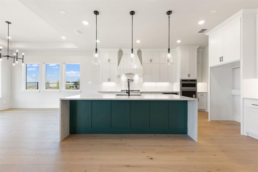 The oversized island is the perfect place for friends and family to gather round.