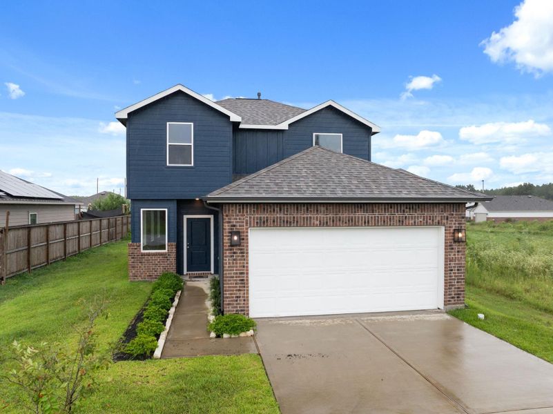 Front exterior of a new home in Santa Fe, Cleveland, TX, highlighting curb appeal (Image 2). Front exterior of a new home in Santa Fe, Cleveland, TX, highlighting curb appeal (Image 2).