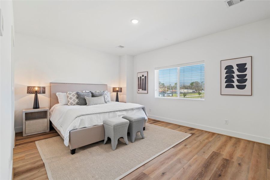 Welcome home to your spacious primary suite oasis. With room enough for seating, this space offers a serene retreat with abundant natural light, elegant flooring, and a well-designed layout perfect for relaxation.