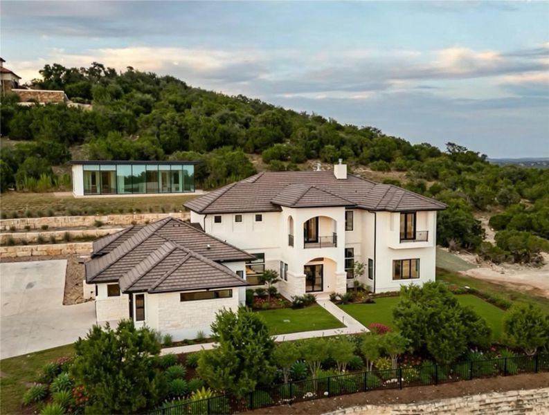 Stucco and stone exterior with a tile roof