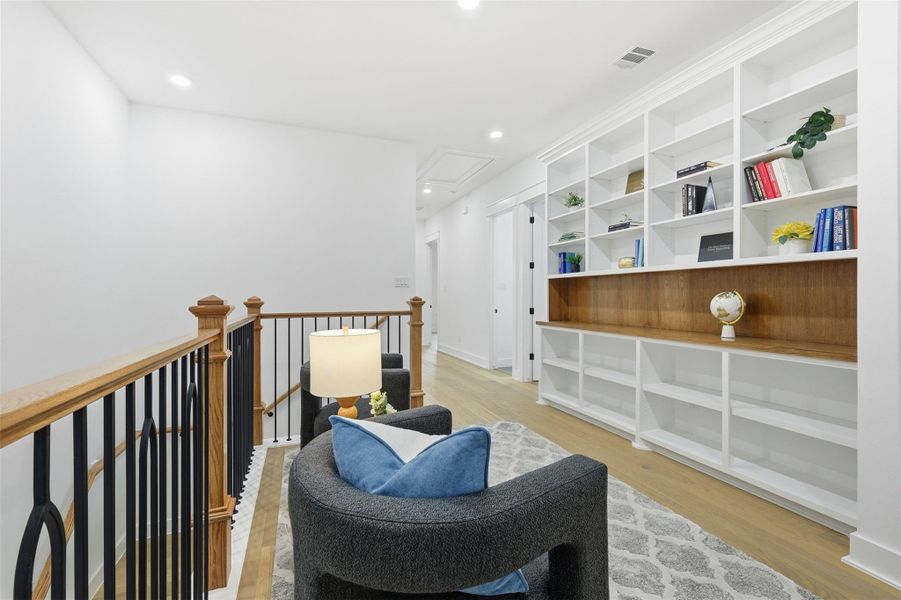 This thoughtfully designed landing includes custom built-in shelving with a warm white oak accent. Perfect for storage, display, or creating a personalized gallery moment.