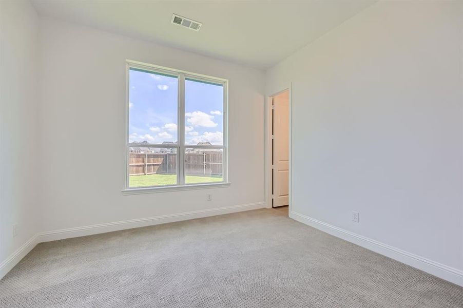 Unfurnished room featuring light carpet