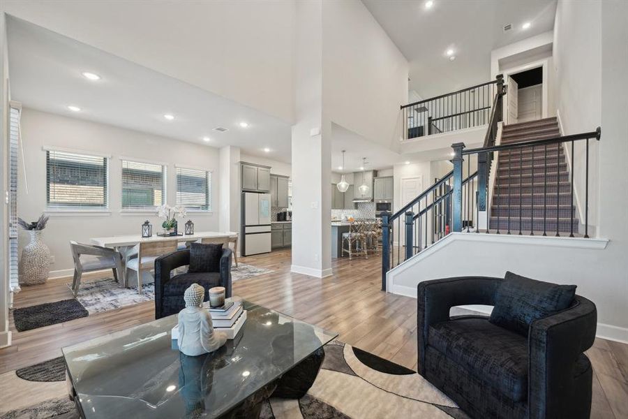 Living room featuring a high ceiling and light wood-type flooring