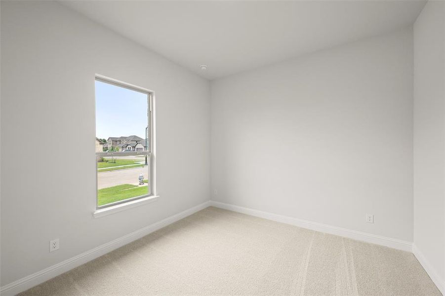 Unfurnished room featuring light colored carpet and plenty of natural light