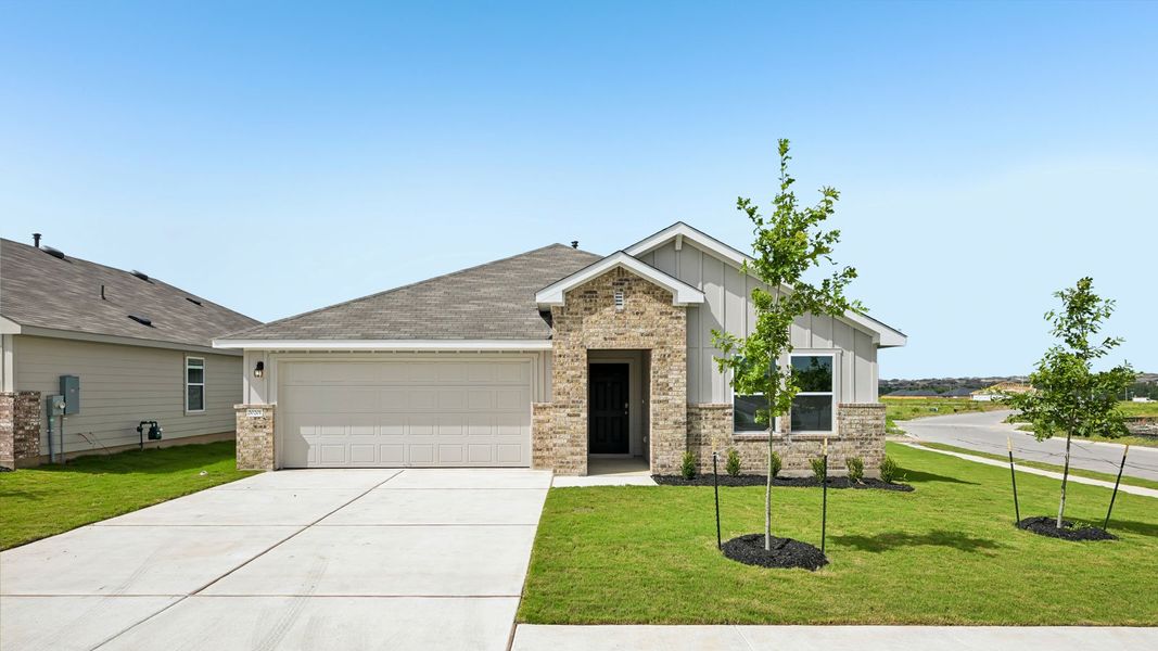 Front exterior of a new home in Carillon, Manor, TX, highlighting curb appeal (Image 2).