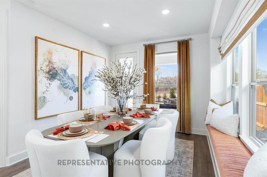 Dining area with dark wood finished floors, healthy amount of natural light, and recessed lighting