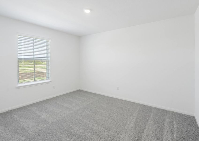 Secondary bedroom with lush carpet flooring