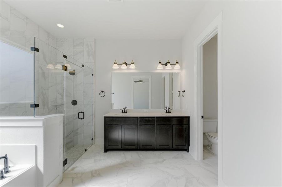 Bathroom with a marble finish shower, double vanity, light marble finish floors, a bath, and recessed lighting