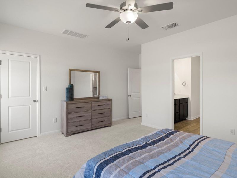 Relax in comfort with plush carpet flooring and a ceiling fan, offering a serene escape.